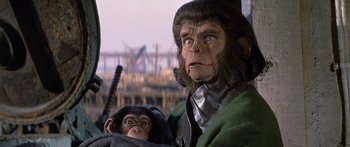 Movie still from “Escape from the Planet of the Apes” (1971), directed by Don Taylor – A man and a chimpanzee in a scene from planet of the apes; Close Up shot, Low angle