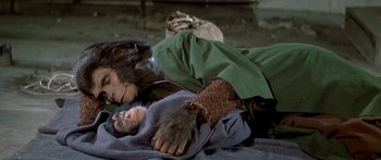 Movie still from “Escape from the Planet of the Apes” (1971), directed by Don Taylor – A man and a monkey are laying on the ground; Close Up shot, High angle