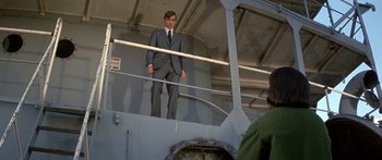 Movie still from “Escape from the Planet of the Apes” (1971), directed by Don Taylor – A man in a suit standing on a boat; Wide shot, Low angle