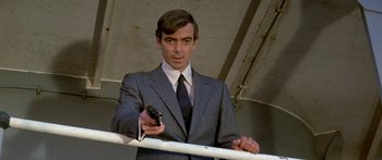 Movie still from “Escape from the Planet of the Apes” (1971), directed by Don Taylor – A man in a suit and tie holding a cell phone; Close Up shot, Low angle