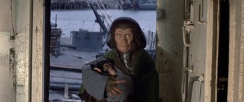Movie still from “Escape from the Planet of the Apes” (1971), directed by Don Taylor – A chimpanzees mother holding a baby in her arms; Close Up shot, High angle