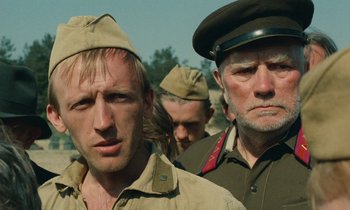 Movie still from “Europa Europa” (1990), directed by Agnieszka Holland – A group of men standing next to each other in military uniforms; Close Up shot, Low angle