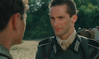 Movie still from “Europa Europa” (1990), directed by Agnieszka Holland – A person wearing a military uniform; Close Up shot, Over the shoulder angle