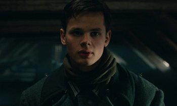 Movie still from “Europa Europa” (1990), directed by Agnieszka Holland – A young man wearing a green jacket and a scarf; Close Up shot, Low angle