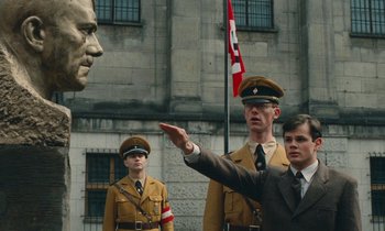 Movie still from “Europa Europa” (1990), directed by Agnieszka Holland – A group of men standing next to each other in uniform; Medium shot, Low angle