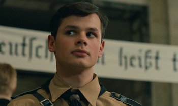 Movie still from “Europa Europa” (1990), directed by Agnieszka Holland – A young man in a uniform looking up at something; Close Up shot, Low angle