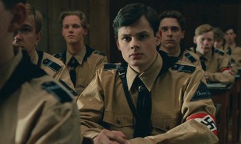 Movie still from “Europa Europa” (1990), directed by Agnieszka Holland – A group of young men in uniform sitting next to each other; Close Up shot, Over the shoulder angle