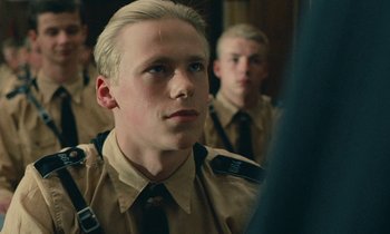 Movie still from “Europa Europa” (1990), directed by Agnieszka Holland – A young man in uniform looking into a mirror; Close Up shot, Low angle