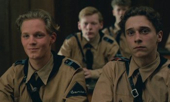 Movie still from “Europa Europa” (1990), directed by Agnieszka Holland – A group of young men sitting in front of each other; Close Up shot, Over the shoulder angle