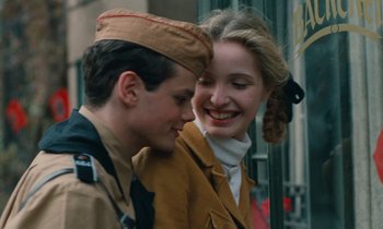 Movie still from “Europa Europa” (1990), directed by Agnieszka Holland – A man and a woman smiling for the camera; Close Up shot, Low angle