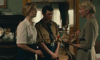 Movie still from “Europa Europa” (1990), directed by Agnieszka Holland – A man and a woman standing next to each other in a room; Medium shot, Over the shoulder angle