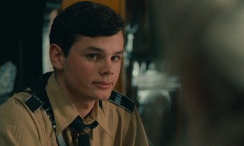 Movie still from “Europa Europa” (1990), directed by Agnieszka Holland – A young man in a uniform is looking at the camera; Close Up shot, Over the shoulder angle