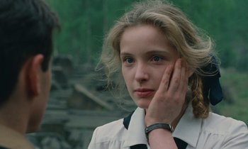 Movie still from “Europa Europa” (1990), directed by Agnieszka Holland – A young woman is holding her hand to her face; Close Up shot, Over the shoulder angle