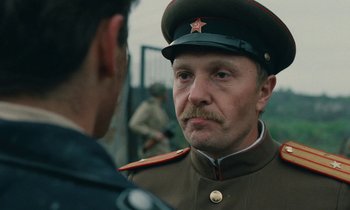 Movie still from “Europa Europa” (1990), directed by Agnieszka Holland – A man in a military uniform talking to another man; Close Up shot, Over the shoulder angle