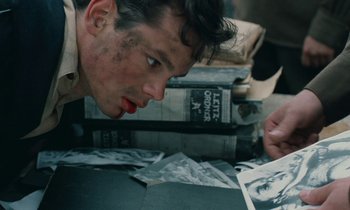 Movie still from “Europa Europa” (1990), directed by Agnieszka Holland – A young man looking at an old photograph; Close Up shot, High angle
