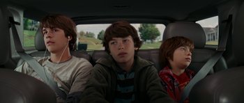 Movie still from “Evan Almighty” (2007), directed by Tom Shadyac – Three young boys sitting in the back seat of a car; Medium shot, Over the shoulder angle