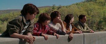 Movie still from “Evan Almighty” (2007), directed by Tom Shadyac – A group of young people sitting on top of a concrete wall; Medium shot, Low angle