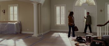 A woman standing in the middle of a living room
