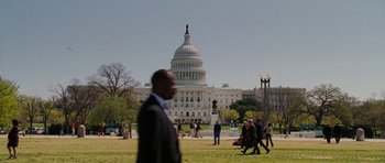 Movie still from “Evan Almighty” (2007), directed by Tom Shadyac – A man in a suit is walking in front of the capitol building; Extreme Wide shot, Low angle