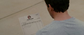 A man looking at a bill of lading in front of him