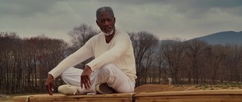 Movie still from “Evan Almighty” (2007), directed by Tom Shadyac – An older man sitting on top of a wooden platform; Medium shot, Low angle