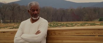 Movie still from “Evan Almighty” (2007), directed by Tom Shadyac – An older man standing in front of a wooden fence; Medium shot, Over the shoulder angle
