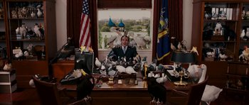 Movie still from “Evan Almighty” (2007), directed by Tom Shadyac – A man sitting at a desk surrounded by pigeons; Medium shot, High angle