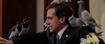 Movie still from “Evan Almighty” (2007), directed by Tom Shadyac – A man in a suit with a bird on his shoulder; Close Up shot, Low angle