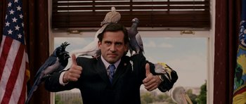 Movie still from “Evan Almighty” (2007), directed by Tom Shadyac – A man in a business suit with pigeons on his shoulders; Medium shot, Low angle