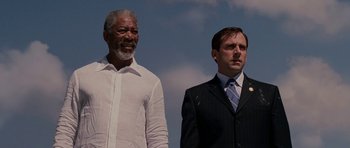 Movie still from “Evan Almighty” (2007), directed by Tom Shadyac – Two men standing next to each other in front of a sky background; Medium shot, Low angle