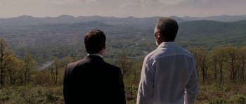 Movie still from “Evan Almighty” (2007), directed by Tom Shadyac – Two men looking out over a valley from a mountain top; Extreme Wide shot, High angle