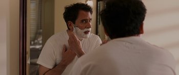 Movie still from “Evan Almighty” (2007), directed by Tom Shadyac – A man shaving his face in front of a mirror; Close Up shot, Over the shoulder angle