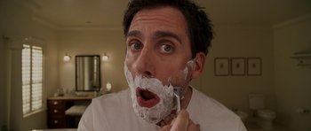 Movie still from “Evan Almighty” (2007), directed by Tom Shadyac – A person shaving with a razor; Close Up shot, Low angle