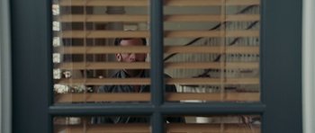 Movie still from “Evan Almighty” (2007), directed by Tom Shadyac – A man looking out a window through a wooden slat fence; Close Up shot, Over the shoulder angle