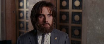 Movie still from “Evan Almighty” (2007), directed by Tom Shadyac – A man in a suit and a tie looking at the camera; Close Up shot, Over the shoulder angle