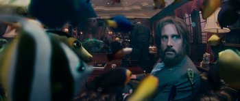 Movie still from “Evan Almighty” (2007), directed by Tom Shadyac – A man sitting at a table with a bunch of stuffed animals flying around him; Medium shot, Low angle