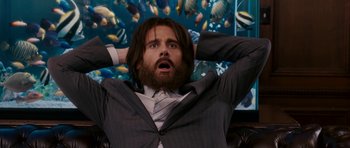 Movie still from “Evan Almighty” (2007), directed by Tom Shadyac – A man with long hair and a beard in a suit and tie; Medium shot, Low angle