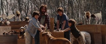 Movie still from “Evan Almighty” (2007), directed by Tom Shadyac – A group of people standing next to each other near a goat; Medium shot, Over the shoulder angle