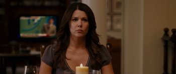 Movie still from “Evan Almighty” (2007), directed by Tom Shadyac – A woman sitting in front of a lit candle; Close Up shot, Over the shoulder angle