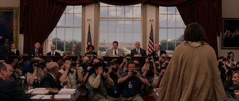 Movie still from “Evan Almighty” (2007), directed by Tom Shadyac – A group of people taking pictures in a room; Wide shot, Low angle