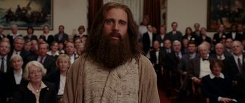 Movie still from “Evan Almighty” (2007), directed by Tom Shadyac – A man with a long beard is standing in front of a group of people; Close Up shot, Low angle
