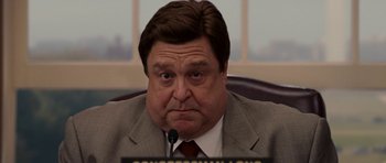 Movie still from “Evan Almighty” (2007), directed by Tom Shadyac – A person sitting at a desk; Close Up shot, Low angle