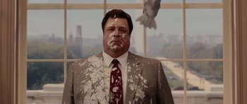 Movie still from “Evan Almighty” (2007), directed by Tom Shadyac – A man in a suit and tie covered in powdery substance; Medium shot, Over the shoulder angle