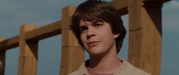 Movie still from “Evan Almighty” (2007), directed by Tom Shadyac – A young man standing in front of a wooden cross; Close Up shot, Low angle