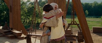 Movie still from “Evan Almighty” (2007), directed by Tom Shadyac – A woman and a boy are hugging each other outside; Medium shot, Over the shoulder angle