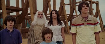 Movie still from “Evan Almighty” (2007), directed by Tom Shadyac – A group of people standing next to each other in a field; Medium shot, Over the shoulder angle