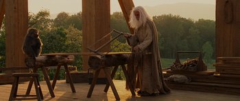 Movie still from “Evan Almighty” (2007), directed by Tom Shadyac – An old man is working on a piece of wood; Medium shot, Low angle