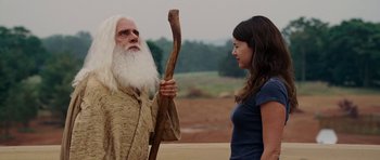 Movie still from “Evan Almighty” (2007), directed by Tom Shadyac – An old man and a young woman standing next to each other; Medium shot, Over the shoulder angle