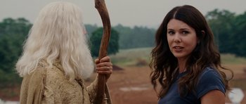 Movie still from “Evan Almighty” (2007), directed by Tom Shadyac – A woman standing next to an old man holding a stick; Close Up shot, Over the shoulder angle