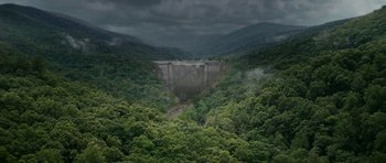 Movie still from “Evan Almighty” (2007), directed by Tom Shadyac – An aerial view of a dam surrounded by a forest; Extreme Wide shot, High angle